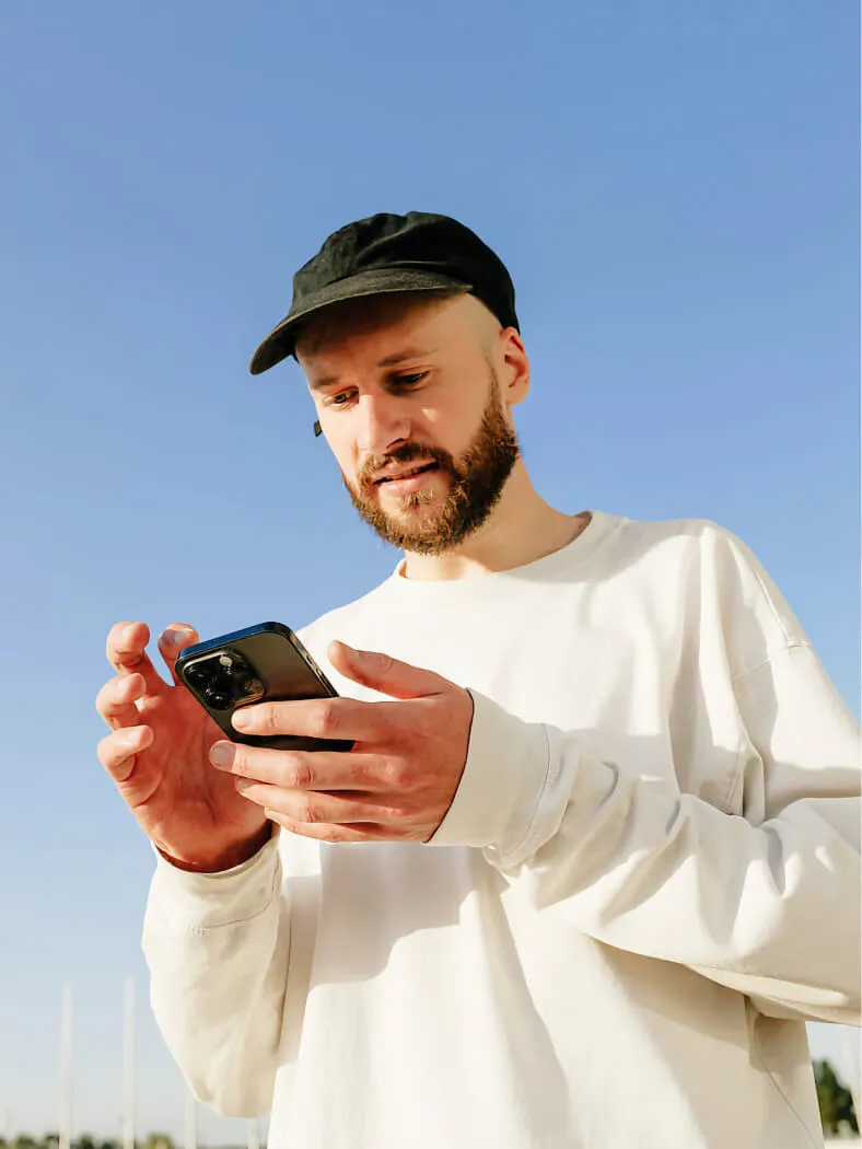 Young man in a casual clothes using a phone