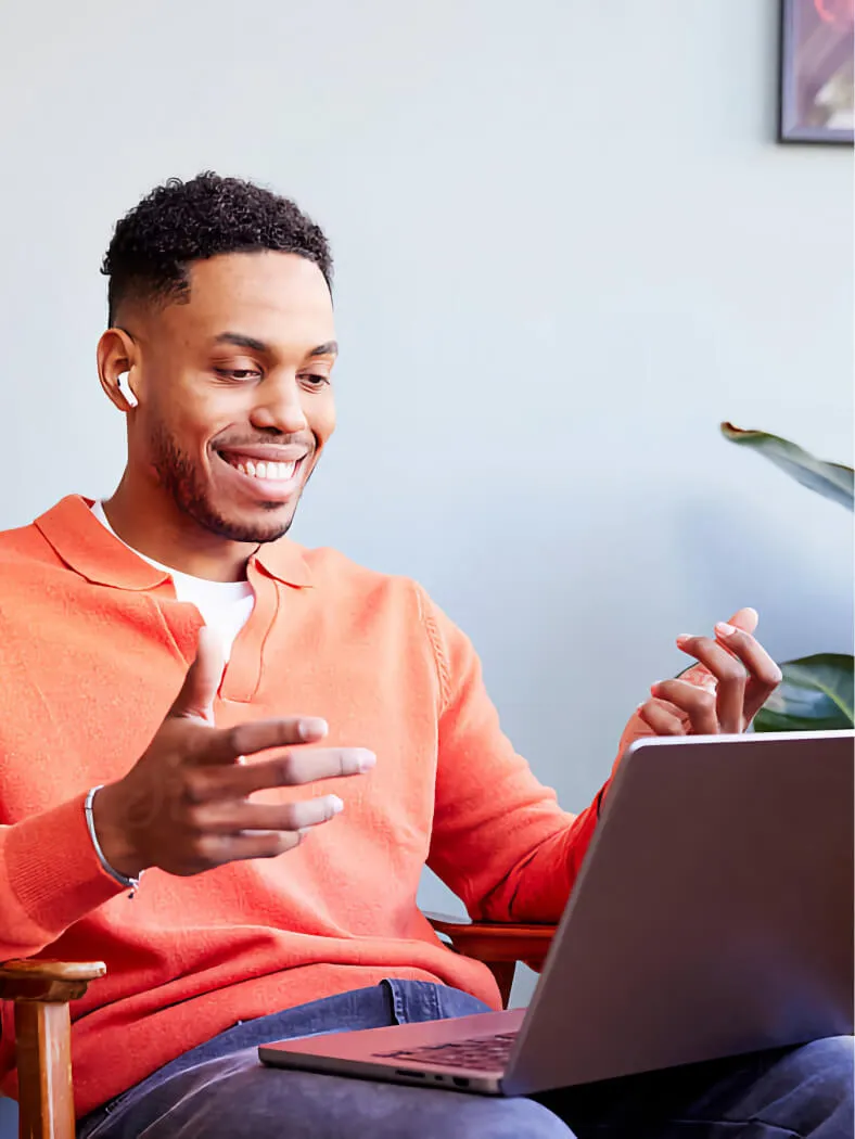 Young Afro-American man sitting with a laptop