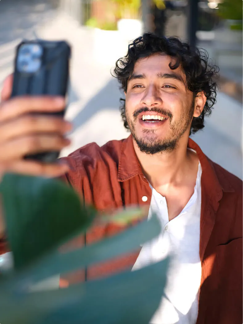 Young smiling man making a selfie with a phone