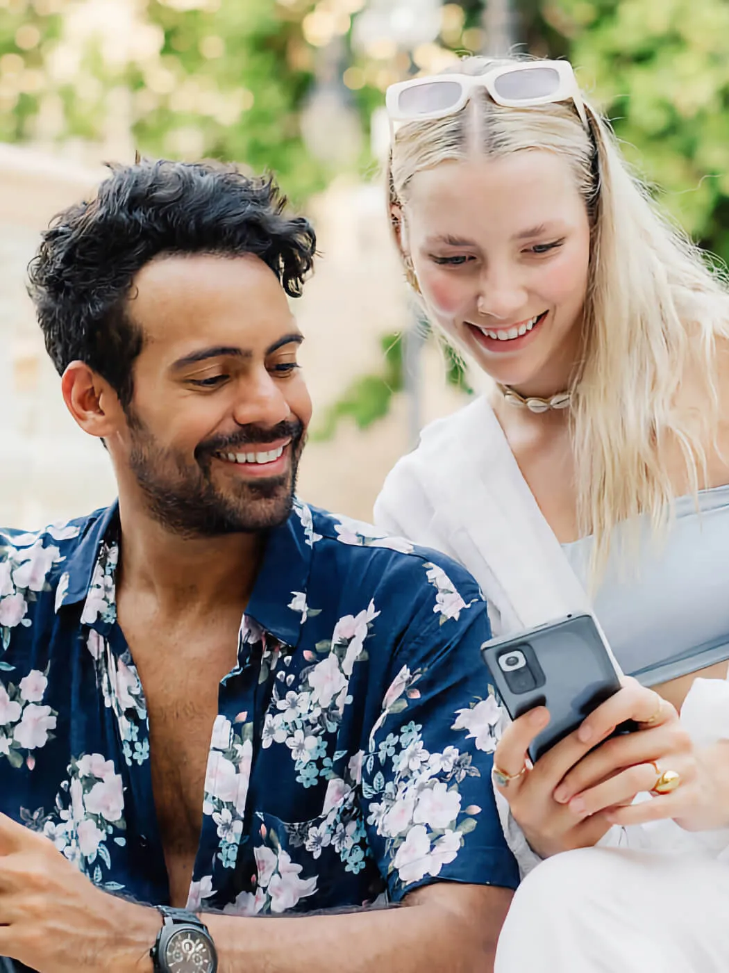 Smiling couple looking into the phones